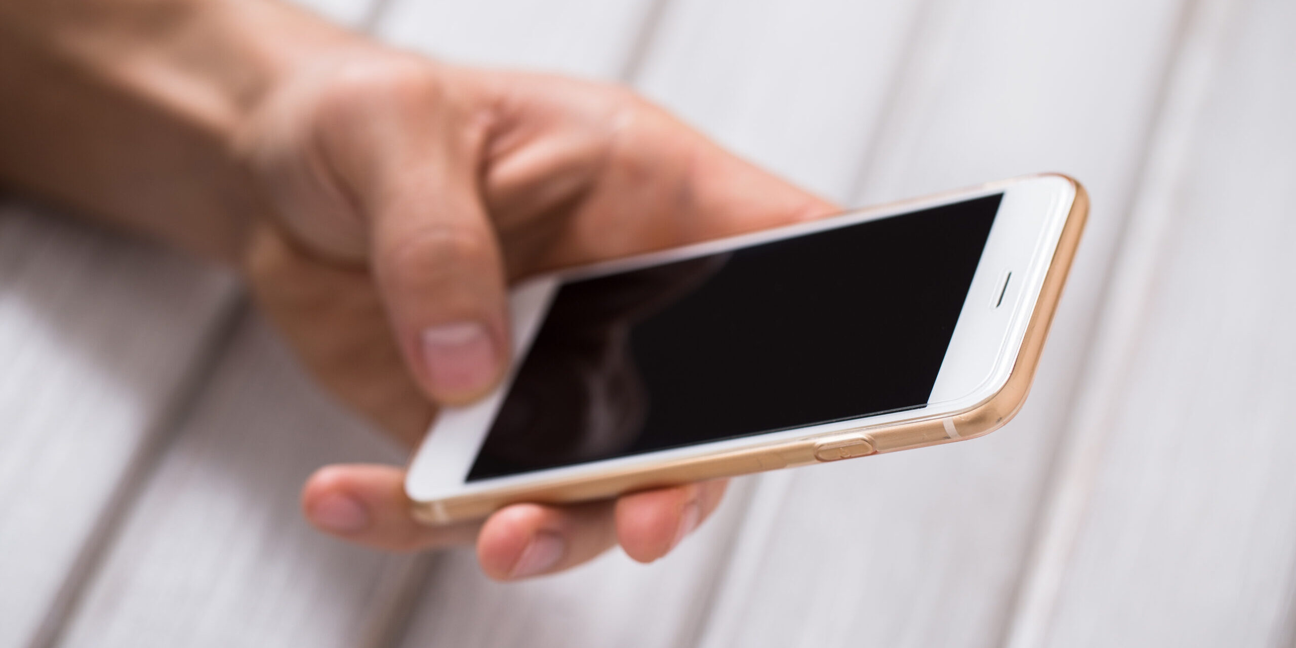 Close up of a man using mobile smart phone